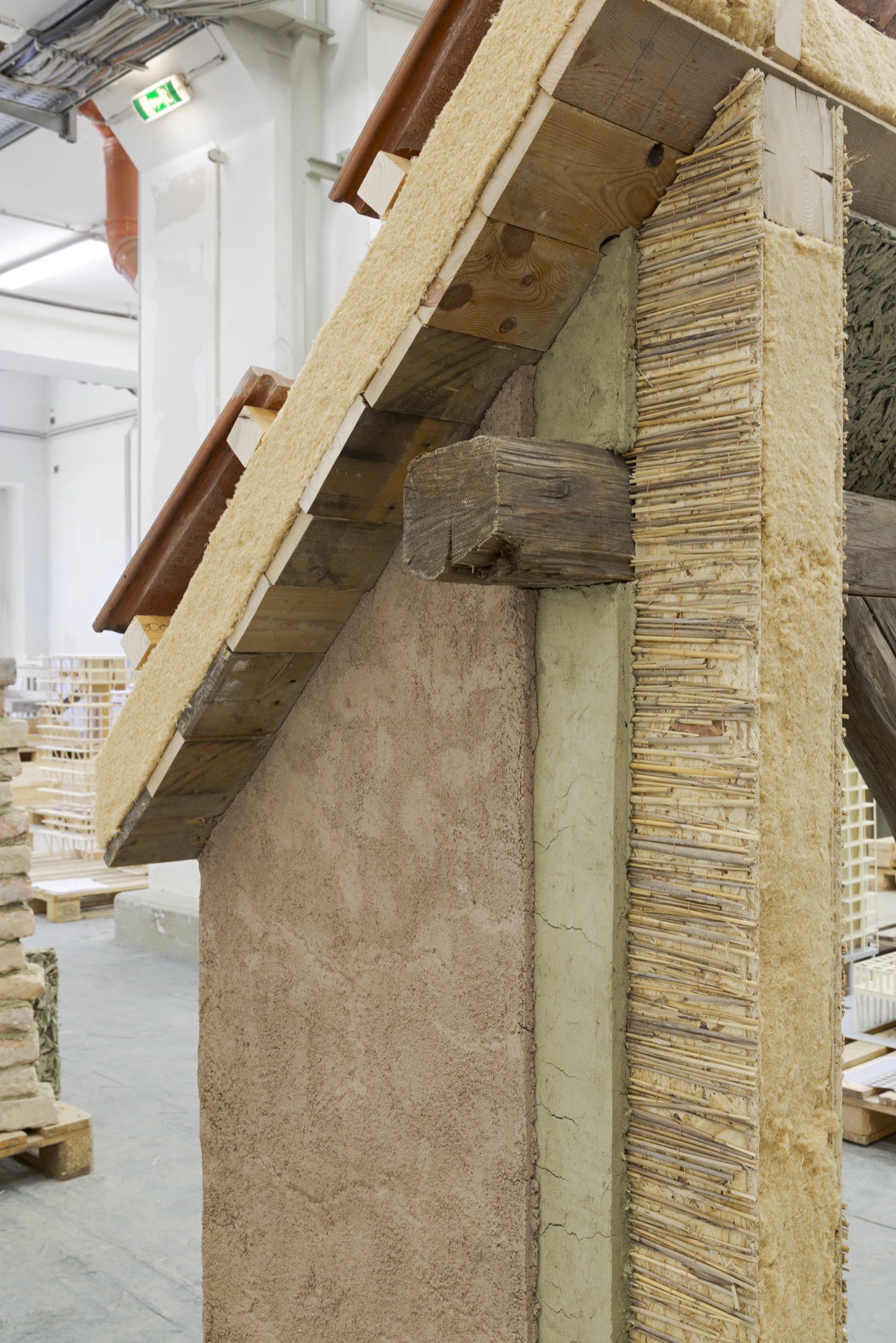 Detail of the loam wall meeting the timber frame