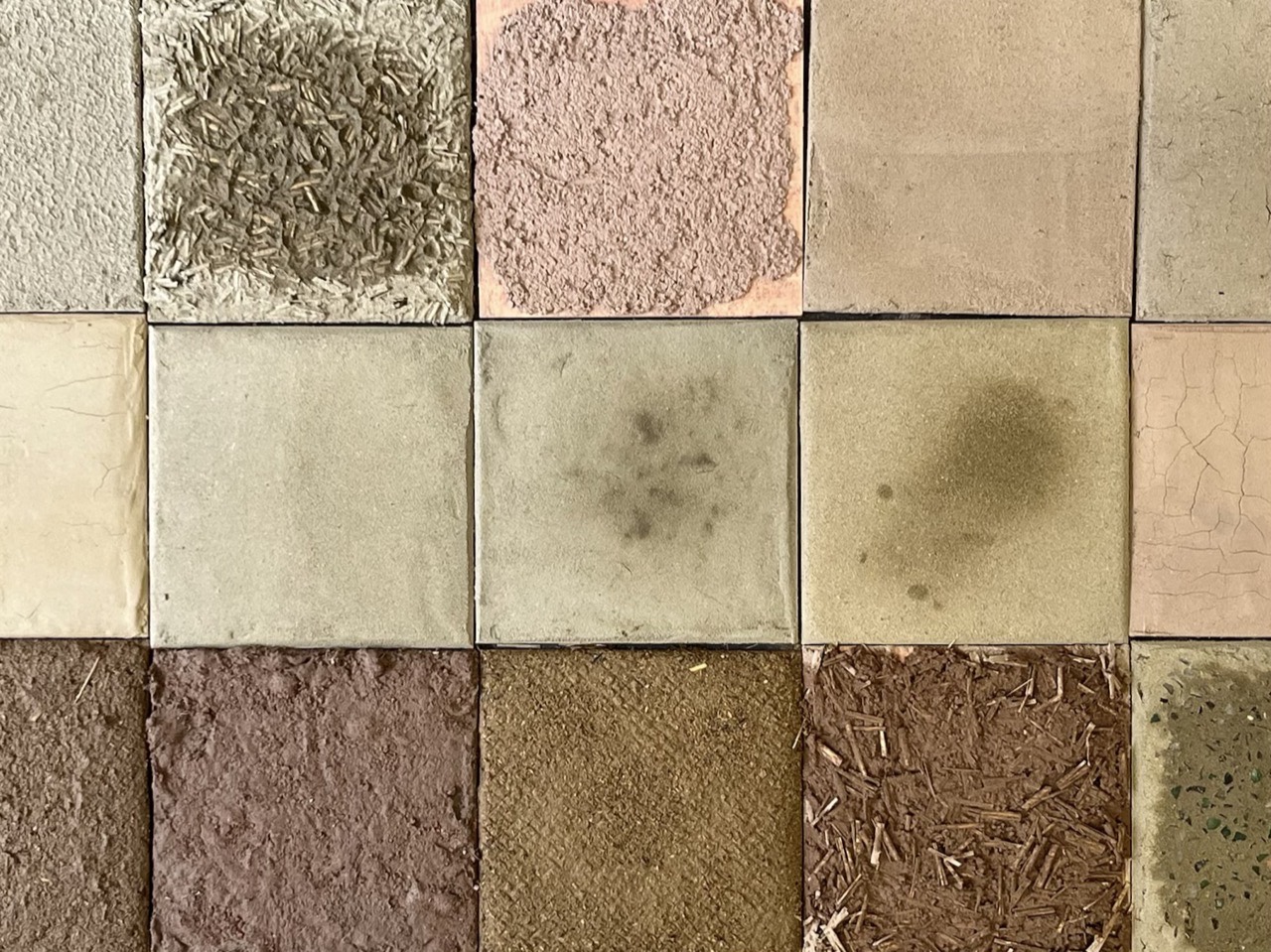 Grid of plaster test tiles in different colours and textures