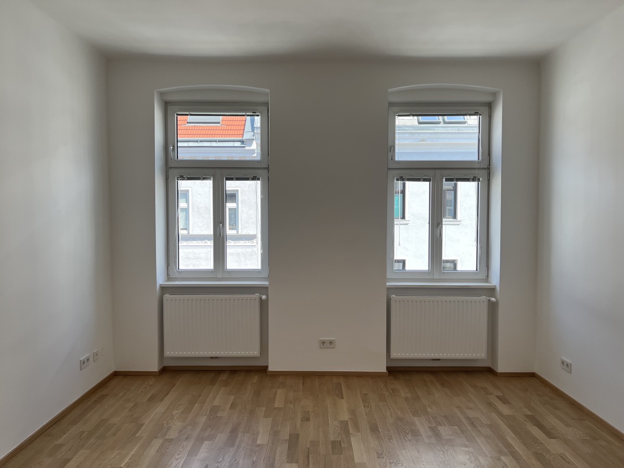 Finished room with two windows to the street